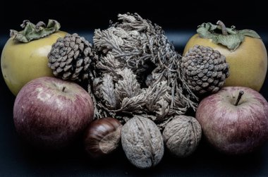 A composition of typically autumnal fruits such as chestnuts, walnuts, persimmons or the Campanian Annurca apple, enhancing their beauty and detail.