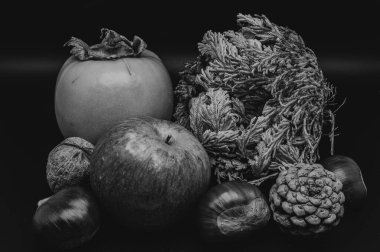 A composition of typically autumnal fruits such as chestnuts, walnuts, persimmons or the Campanian Annurca apple, enhancing their beauty and detail.