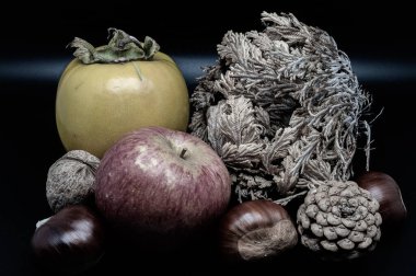 A composition of typically autumnal fruits such as chestnuts, walnuts, persimmons or the Campanian Annurca apple, enhancing their beauty and detail.