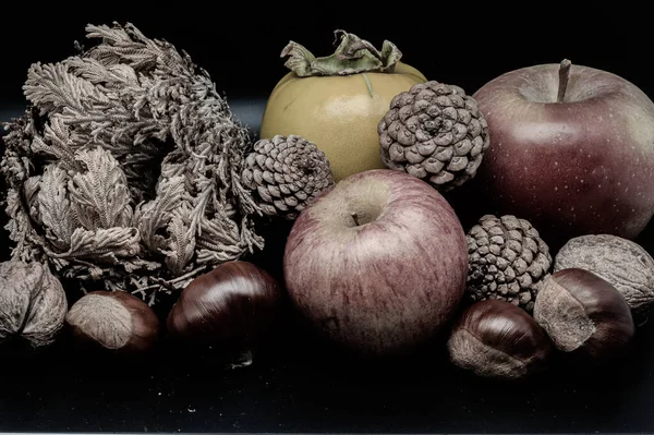 A composition of typically autumnal fruits such as chestnuts, walnuts, persimmons or the Campanian Annurca apple, enhancing their beauty and detail.