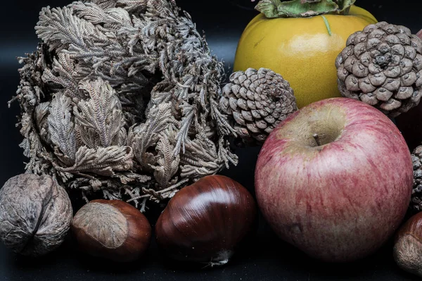 A composition of typically autumnal fruits such as chestnuts, walnuts, persimmons or the Campanian Annurca apple, enhancing their beauty and detail.