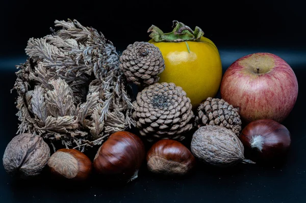 A composition of typically autumnal fruits such as chestnuts, walnuts, persimmons or the Campanian Annurca apple, enhancing their beauty and detail.