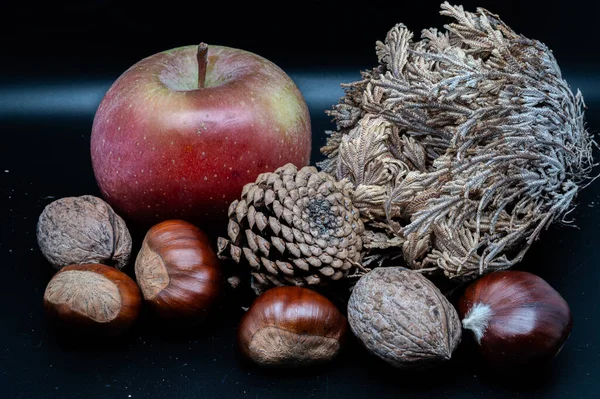 A composition of typically autumnal fruits such as chestnuts, walnuts, persimmons or the Campanian Annurca apple, enhancing their beauty and detail.