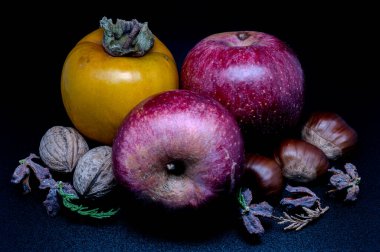 A composition of typically autumnal fruits such as chestnuts, walnuts, persimmons or the Campanian Annurca apple, enhancing their beauty and detail.