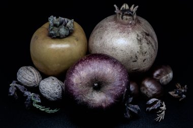 A composition of typically autumnal fruits such as chestnuts, walnuts, persimmons or the Campanian Annurca apple, enhancing their beauty and detail.