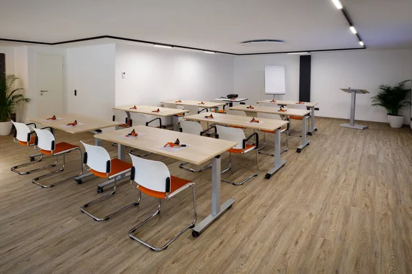 Parlak bir modern eğitim odasında sandalyeler ve banklar vardır.