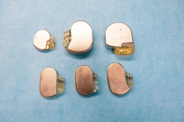 Various Pacemakers Implantable Defibrilators Lie Light Blue Base — Stock Photo, Image