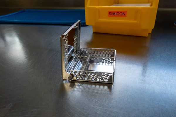 a simicon test for checking the cleaning performance of a washing machine in the operating room stands on a silver base