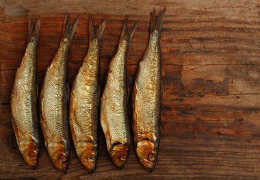 herring sprat fish smoked wooden table clipart