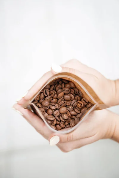 Coffee beans in the palms. Coffee aromaniac