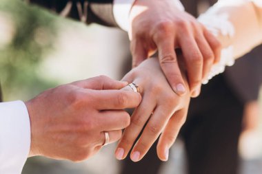 Gelin ve damadın elinde alyanslar.