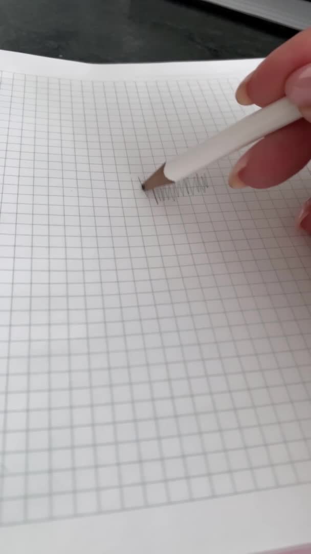 Hand writes with a pencil in a notebook — Stock Video