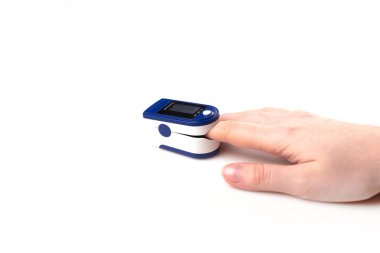 Close up of Finger and hand in an Oximeter Device. Pulse oximeter on white background clipart