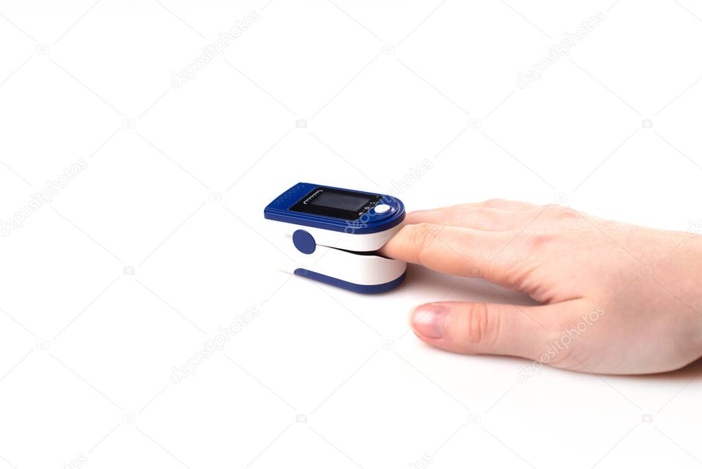 Close up of Finger and hand in an Oximeter Device. Pulse oximeter on white background