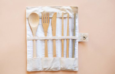 Bej arka planda yeniden kullanılabilir çevre dostu Bambu çatal bıçak seti, alternatif aksesuar, sıfır atık ve plastiksiz konsept. Boşluğu kopyala.