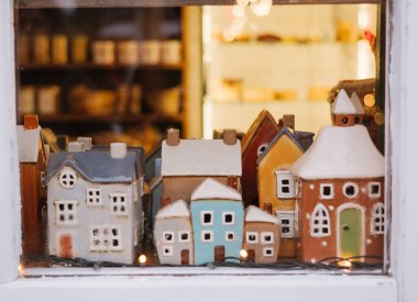 Mağaza vitrininde seramik evler sergileniyor. 