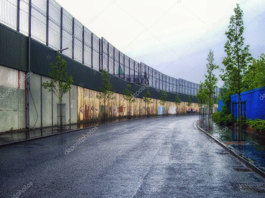 A section of one of the so-called peace walls or peace lines, that separate nationalist and unionist (or Catholic and Protestant) neighbourhoods in Belfast, Northern Ireland.