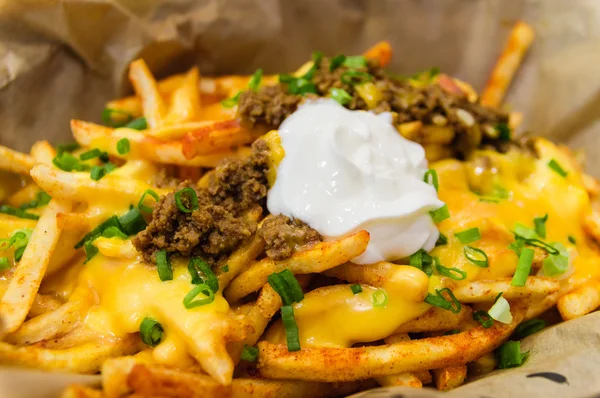 Melting cheddar cheese Loaded Fries — Stock Photo, Image