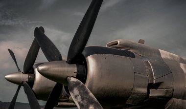Old propeller airplane, vintage sepia black and white tone, against the sky background. Propeller and turbine detail