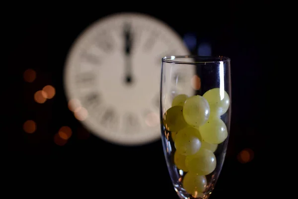 CELEBRATION OF THE NEW YEAR, TRADITION OF TWELVE GRAPES OF LUCK WITH THE CLOCK WITH TWELVE BELLS