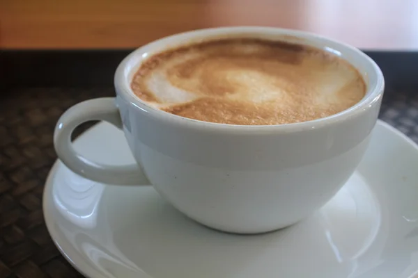 Cappuccino coffee on wooden table — Stock Photo, Image