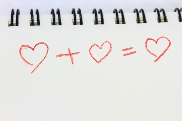 Drawing heart on white notebook — Stock Photo, Image
