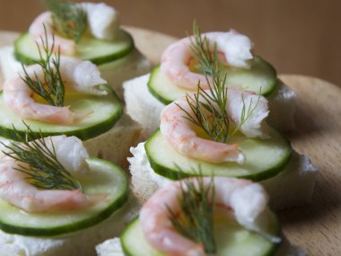 Canape with cream cheese, cucumber and shrimp