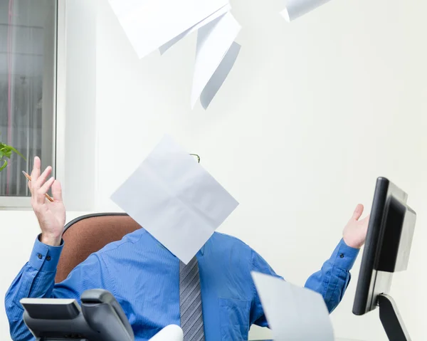 Executive at desk throws papers in air — Stock Photo, Image