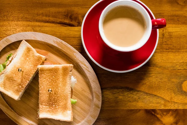 Cup of coffee and saucer on table with toast — Stock Photo, Image