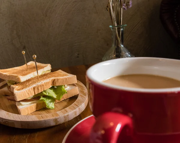 Cup of coffee and saucer on table with toast — Stock Photo, Image
