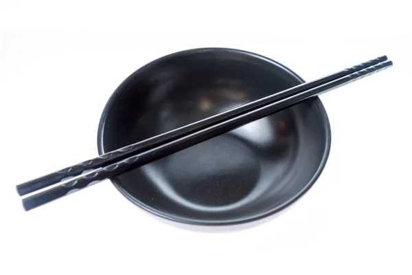 Black chopsticks on bowl — Stock Photo, Image