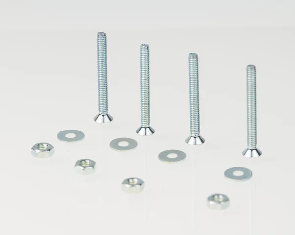 Screws, nuts, and bolts on isolated white background — Stock Photo, Image