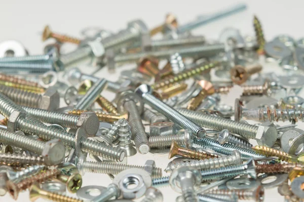 Screws, nuts, and bolts on isolated white background — Stock Photo, Image