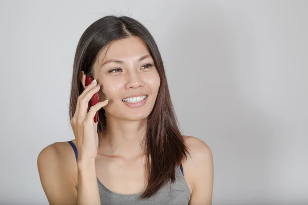 Asian woman talking on smartphone — Stock Photo, Image