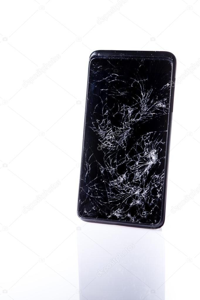 Mobile smartphone with broken screen on white with reflection
