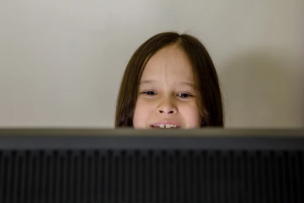 Young girl looking at computer screen