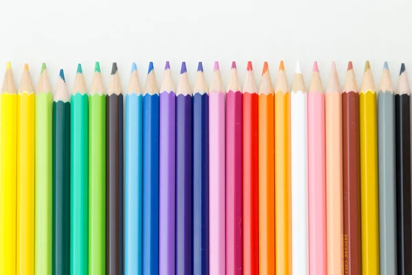 Row of color pencil crayons — Stock Photo, Image