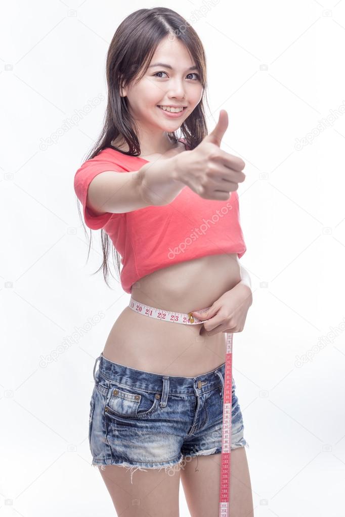 Asian woman measuring waist