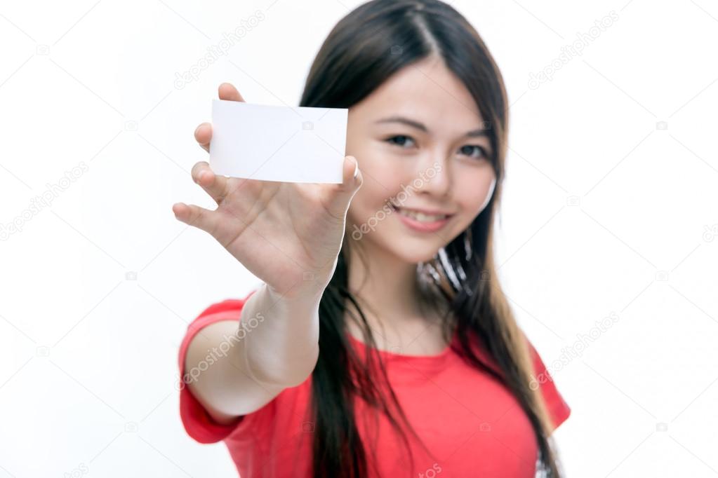 Asian woman holding up blank business card