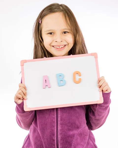Młoda dziewczyna trzyma znak z Abc — Zdjęcie stockowe