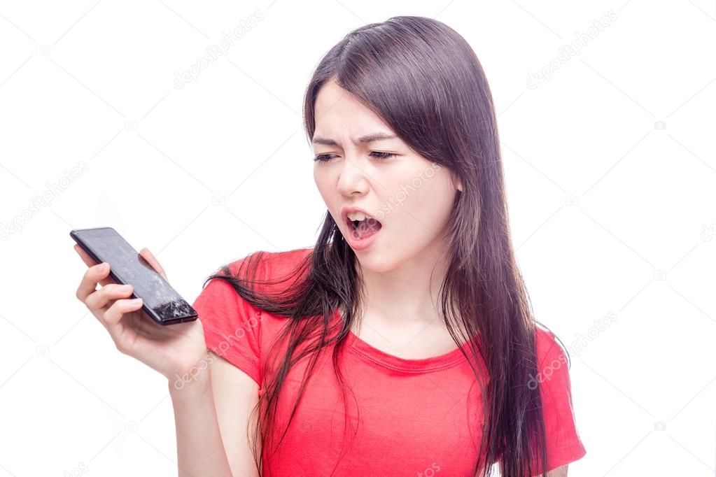 Chinese woman frowning at broken cell phone