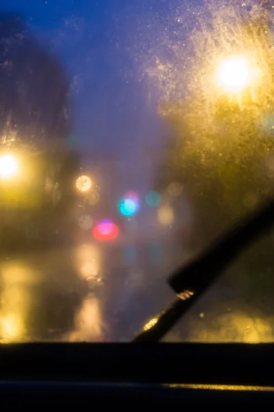 Blurred view through rain on windshield — Stock Photo, Image