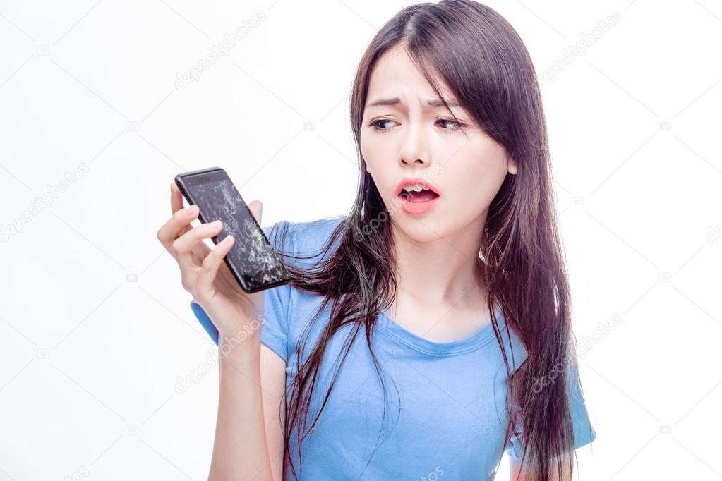 Chinese woman staring at broken cell phone