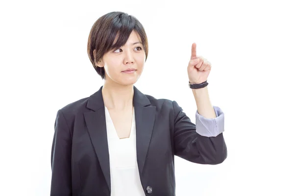 Asian businesswoman pressing invisible screen — Stock Photo, Image