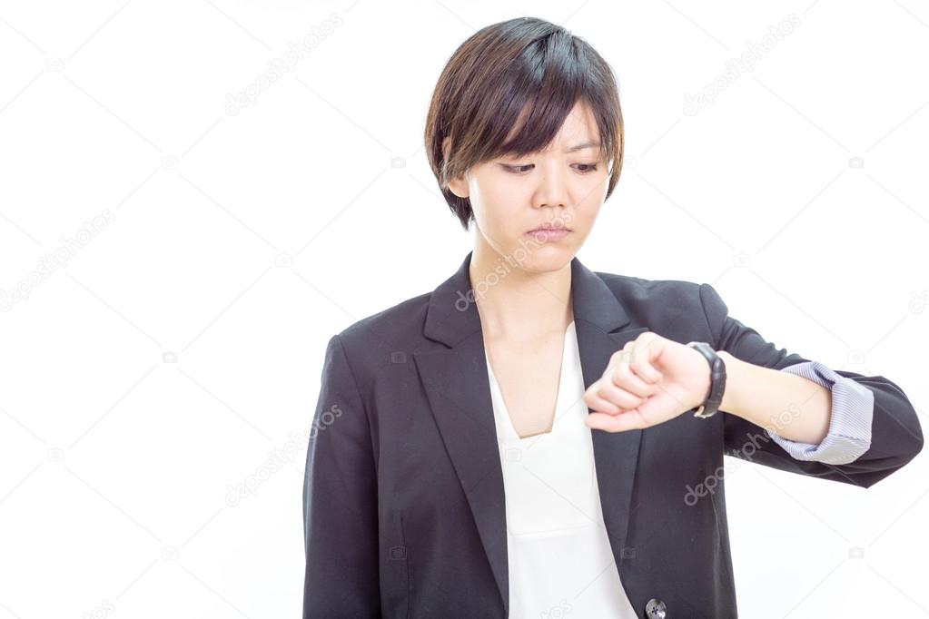 Asian businesswoman looking at watch