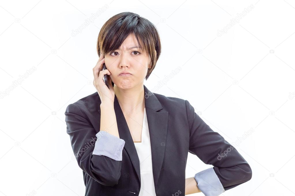 Annoyed Asian businesswoman on cell phone