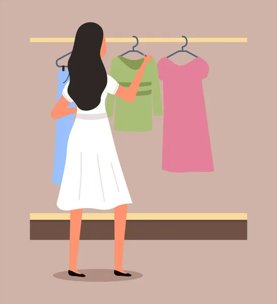 Girl chooses clothes on the hanger on shopping. Female buyer is selecting clothes in a store — Stock Vector