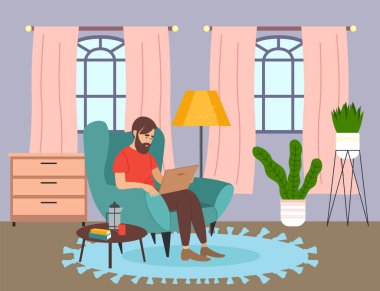 Adamın biri dizüstü bilgisayar kullanıyor, evdeki koltukta oturuyor. Rahat bir yaşam alanı. İnternette sörf yap. Düz resim