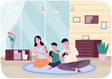 Aile video oyunu oynuyor. Anne, baba ve oğul oyun oynarken oyun konsolu ellerinde.