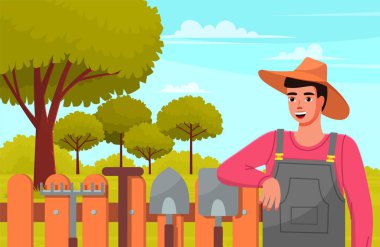 Male gardener in summer garden landscape with green trees wood fence and garden tools against forest